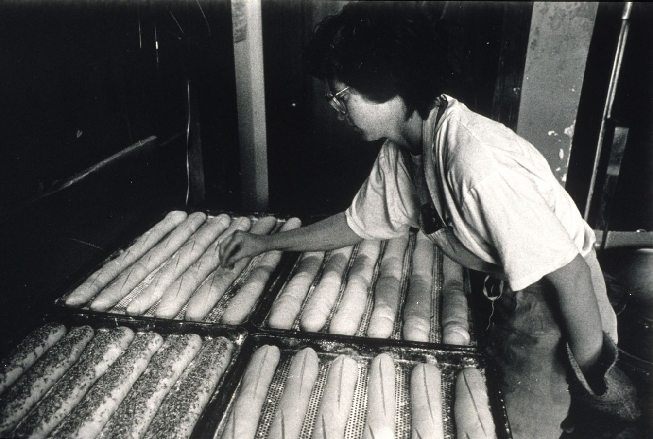Black and white photo of woman making bread