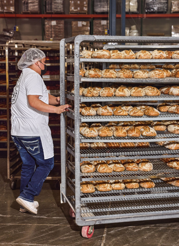 Semifreddis employee rolling bakery cart