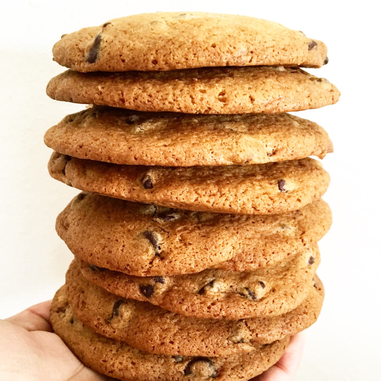 Photo of hand holding stack of cookies