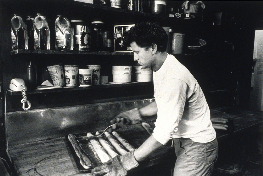 Black and white photo of man making bread