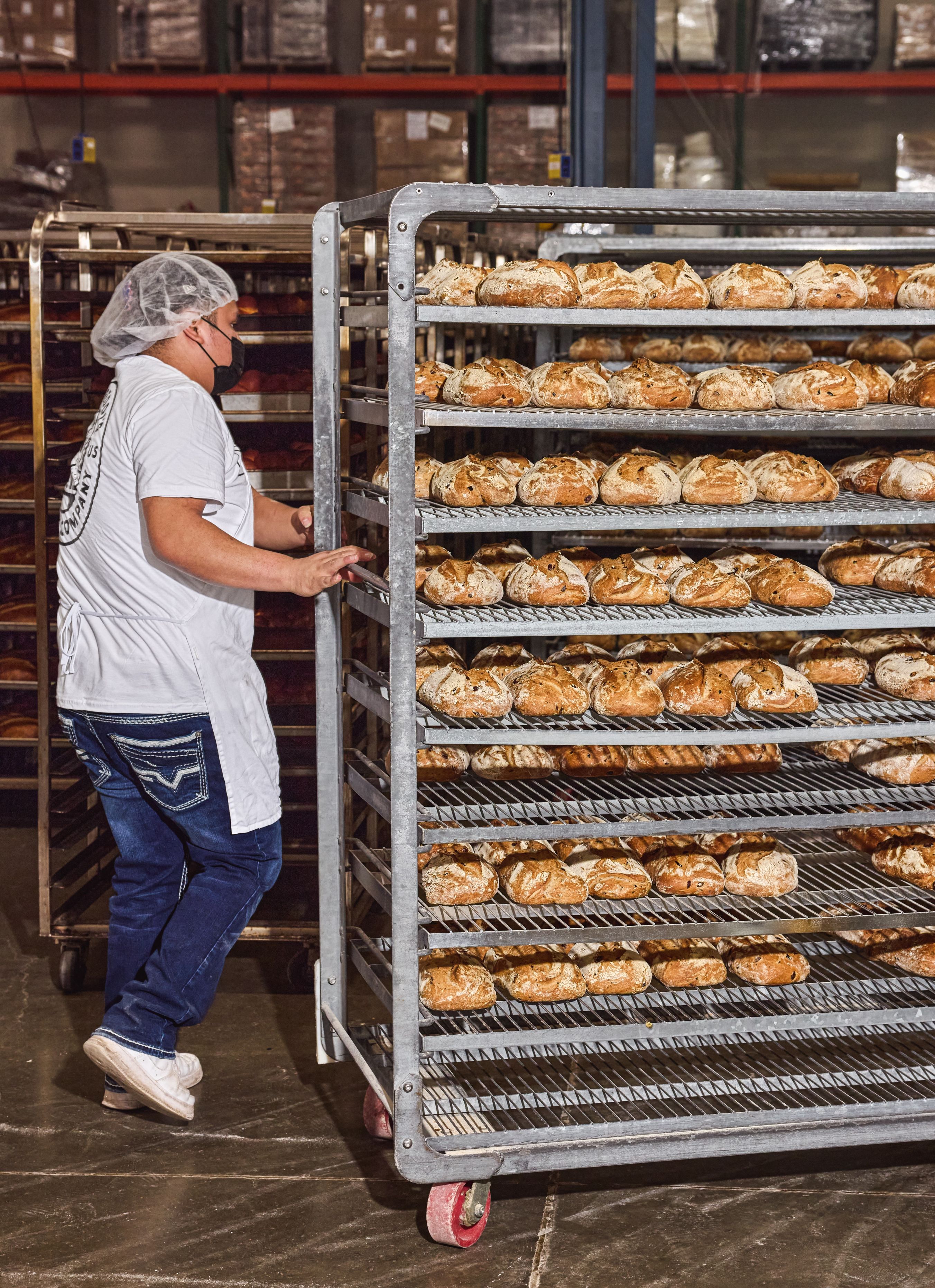 Semifreddis employee rolling bakery cart